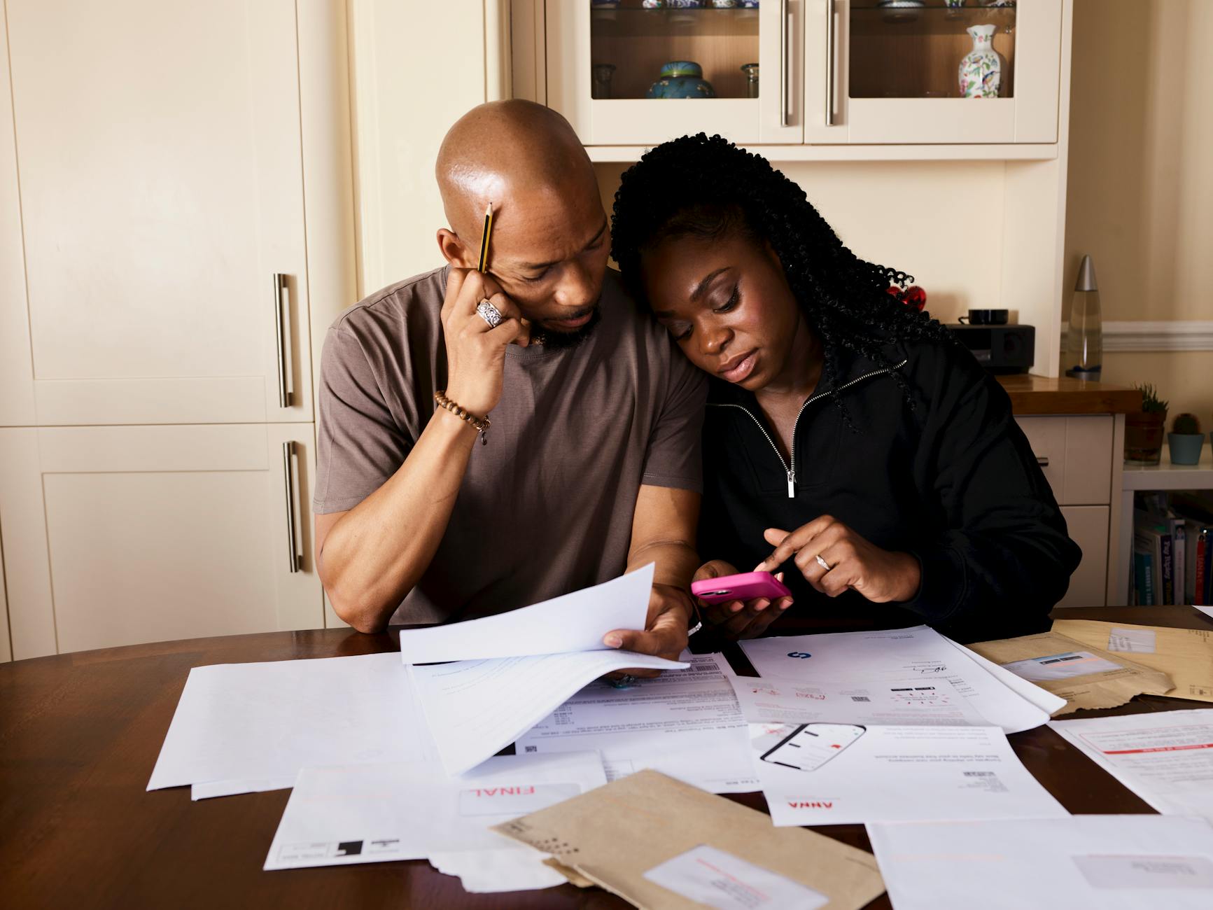 Two side-by-side phones representing shared budgeting tools for couples